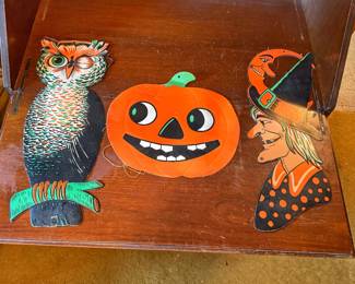 Three classic mid-century die-cut cardboard Halloween decorations.