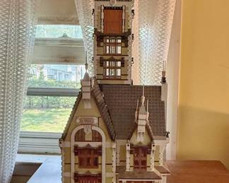 The LEGO Icons Haunted House (Set #10273) is an advanced, retired 3,231-piece building kit featuring a functional free-fall drop tower ride, opening hinged design, and classic manor details.
