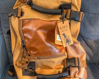 This Kaka canvas convertible travel backpack features durable water-resistant fabric, heavy-duty dual grab handles, and a versatile design that flips into a duffel bag.