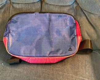 This Rareforn Zion sling bag feautyres a vibrant blue and pink colorway crafted from unique repurposed billboard vinyl.