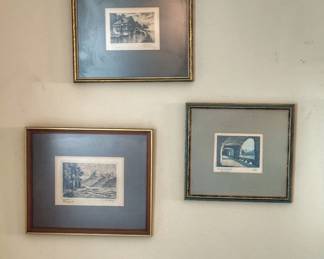 A collection of three vintage framed etchings depicting scenic landscape and architectural views.