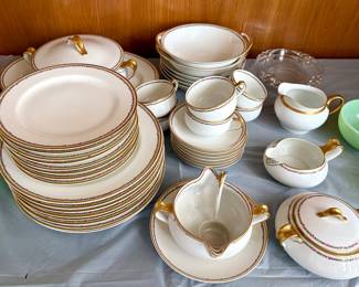 a large set of vintage fine porcelain Haviland & Co. Limoges dinnerware featuring pink floral garlands and gilt gold trim.