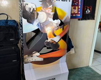 This is an official promotional store display featuring Tracer from Blizzard Entertainment’s hero shooter Overwatch