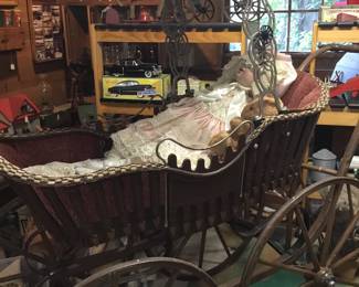 120.  Antique baby carriage with doll