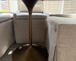 the RH Aero Round Dining Table with dark walnut top and antiqued brass pedestal base,