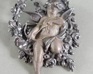 Lot 389 Sterling silver Cupid brooch