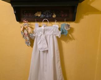 Hand crafted shelf with pitchers; Baptismal dress with bonnet
