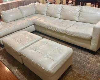 White leather sofas with ottomans