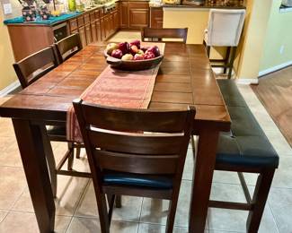 Wooden high top dining table, 4 chairs, and one stool