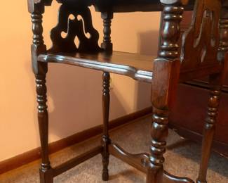 Vintage tiered wood side table / accent table with turned legs, lower shelf, and decorative pierced side panels. Traditional styling with a warm dark wood finish and an unusual architectural shape. Researched prior to sale.