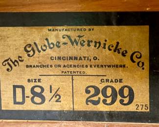 Original Globe-Wernicke manufacturer label on the barrister bookcase. Label reads The Globe-Wernicke Co., Cincinnati, Ohio, size D-8½, grade 299. Original labeling supports the piece’s identification and provenance.