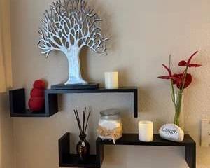 Modern Black Floating Wall Shelves with Assorted Decorative Accents