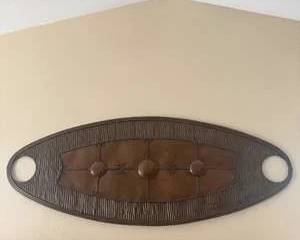 Oval Metal Wall Décor with Brown Center & Four Raised Accents