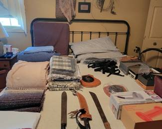 Blankets. Swords. Shoes. Bed with metal frame