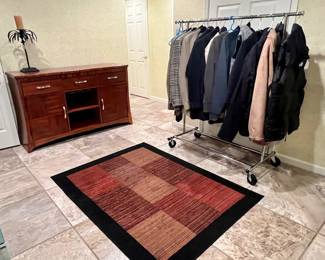 Rack of Mens jackets and credenza that goes with the table and chairs upstairs.