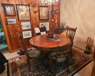 Gorgeous vintage table with assorted vintage chairs.