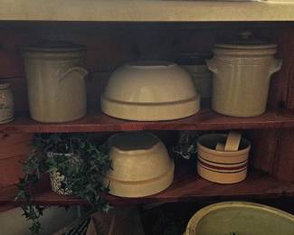 Stoneware crock mixing bowls and other assorted crocks.