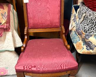 Eastlake chair on casters with hip braces and satin/taffeta like fabric.