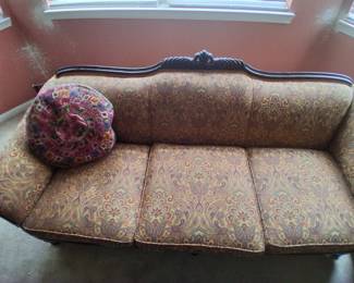 Settee with dark wood frame with carved detail
