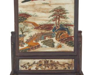 1034 A Chinese polychrome and gilt marble table screen 20th century Depicting a landscape, framed and raised in a carved wood stand Height 14 3/8 in., width 10 5/8 in., depth 4 1/2 in. Estimate: $300 - $500