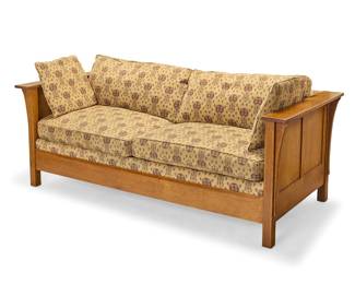 1343 A Stickley oak 'Prairie' settle, no. 922 2002 With factory burn mark and applied metal Mission Reissue label; thrice stamped: 89 9220; dated to paper label With corbeled armrests and arrow pattern cotton upholstery cushions Height 30 in., width 81 1/4 in., depth 37 in. Estimate: $700 - $900
