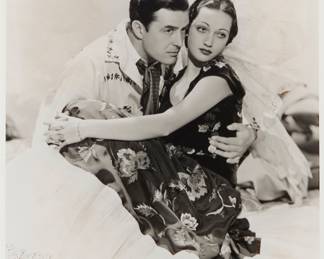 1269 George Hurrell (1904-1992) A portrait of Johnny Mack Brown and Dorothy Lamour Photograph on paper From the edition of unknown size and date Appears unsigned Image: 9 1/2 x 7 1/2 in. Estimate: $200 - $300