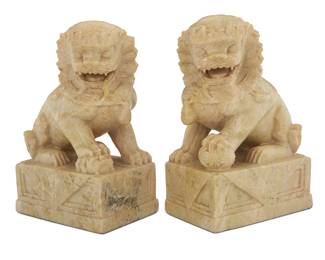 1144 A pair of Chinese carved soapstone guardian lions 20th century Each unmarked 2 pieces Height of each 7 1/4 in., width 5 in., depth 3 3/8 in. Estimate: $150 - $250