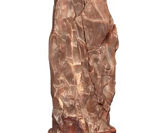 1296 A Chinese style scholar stone 20th century Raised on a wood base Overall height 9 3/4 in., width 4 1/4 in., depth 3 in. Estimate: $200 - $300