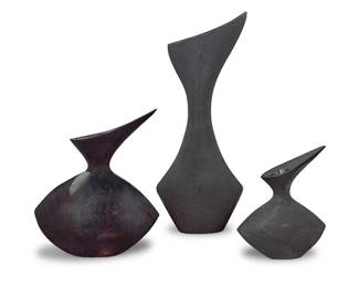 1290 Three R & Y Augousti sculptural vases Early 21st century Each stamped with factory mark Wood and overlay, the largest and smallest each in shagreen, the middle in pen shell 3 pieces Tallest height 23 1/4 in., width 10 /2 in., depth 3 5/8 in.; shortest height 10 1/4 in., width 8 5/8 in., depth 4 in. Estimate: $600 - $900