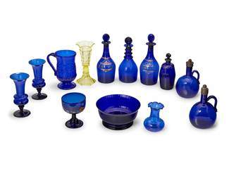 1107 A collection of Bristol blue and other glass table items Late 18th-20th century Comprising various bowls, vases, decanters, and cruets, together with a yellow molded glass vase 13 pieces Tallest height 11 1/2 in., diameter 4 1/4 in.; height of bowl 4 in., diameter 8 1/8 in. Estimate: $500 - $700