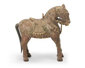 1103 A Chinese Tang dynasty style carved wood horse 19th/20th century With detailed saddlery and remnants of polychrome Height 26 1/8 in., width 24 1/2 in., depth 12 1/2 in. Estimate: $200 - $300