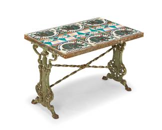 1111 A tile top cast iron low table 20th century With Moorish/Spanish Revival figural pattern glazed ceramic tiles raised on a painted iron base with scroll supports Height 17 1/4 in., width 25 1/2 in., depth 16 1/2 in. Estimate: $300 - $500