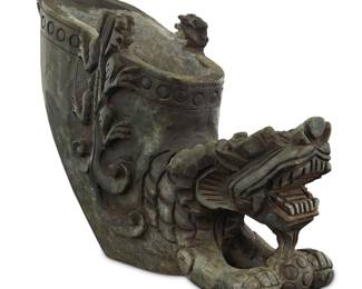 1257 A Chinese carved stone brush pot 20th century Of dragon form, with smaller dragons in relief at the rim Height 8 1/4 in., width 10 3/8 in., depth 3 1/4 in. Estimate: $150 - $250