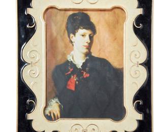 1008 A Jay Strongwater Art Deco style frame Late 20th century Debossed verso: JAY STRONGWATER ® Gilt metal, enamel, and cut glass accents, with easel back Sight 6 5/8 x 4 5/8 in., irregular; frame overall height 9 3/4 in., width 7 3/4 in., depth 5/8 in. Estimate: $200 - $300