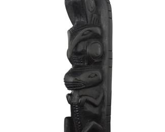 1084 A Northwest Coast style painted carved wood model totem Late 20th century Unmarked Height 11 7/8 in., width 4 1/2 in., depth 3 1/8 in. Estimate: $50 - $100