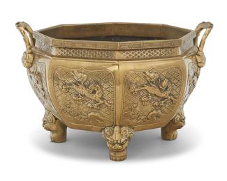 1178 A Chinese brass octagonal jardinière 20th century Unmarked With opposed handles and guardian lions in relief, raised on lion-form feet Height 10 in., width 15 3/4 in., depth 14 in. Estimate: $300 - $500