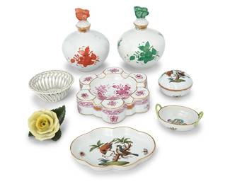 1051 A group of eight Herend porcelain table items 20th century Each with blue printed factory mark above painted shape number and pattern Comprising two 'Chinese Bouquet' perfume bottles, 'Apponyi Purple' ashtray, 'Queen Victoria' ring dish, 'Rothschild Bird' tray, trinket box, and small basket, and a yellow rose 8 pieces Height of each perfume 5 5/8 in., diameter 4 in.; rose height 1 7/8 in., width 3 in., depth 2 7/8 in. Estimate: $300 - $500