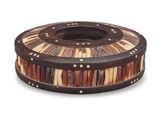 1033 An Anglo-Indian ebony and porcupine quill inkwell Circa late 19th/early 20th century With bone inlaid accents Height 2 in., diameter 6 in. Estimate: $100 - $150