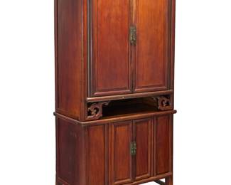 1256 A Chinese wood cabinet Mid-20th century The upper cabinet doors opening to reveal two shelves and two drawers, above front carved cloud elements, the lower cabinet doors revealing an open compartment Height of upper console 47 3/4 in., width 39 3/4 in., depth 20 1/2 in.; height of lower console 33 1/4 in., width 39 1/4 in., depth 20 in. Estimate: $600 - $800