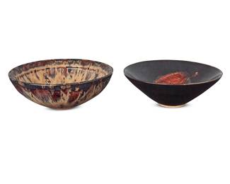 1039 Two Chinese glazed pottery bowls 20th century Each with applied wax export seal to underside Comprising one flambé glazed and one Jizhou-style oxblood glazed decorated with burnt leaf resist 2 pieces Flambé height 2 1/2 in., diameter 6 5/8 in.; height of other 2 3/8 in., diameter 6 1/4 in. Estimate: $600 - $800