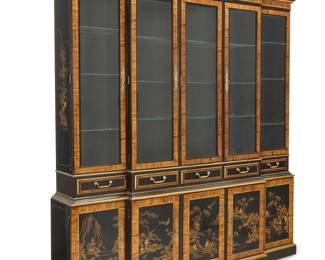 1073 A Drexel Heritage chinoiserie breakfront cabinet Late 20th century Factory burn mark to one drawer; numbered to applied label: 049195 With Asian-style motifs on black lacquer, accented by burlwood trimming, with five glazed cabinet doors, each opening to reveal three glass shelves and an interior light, above six drawers and six lower cabinets each with single shelf, electrified Overall height 84 3/4 in., width 79 in., depth 15 3/4 in. Estimate: $300 - $500