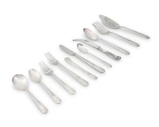 1203 An International sterling silver 'Orchid' part flatware service Mid-20th century Designed 1929 Each with factory marks for sterling Comprising: 5 dinner knives (8 1/2 in.) 11 butter spreaders (5 3/4 in.) 4 dinner forks (7 5/8 in.) 4 salad forks (6 3/8 in.) 8 oval soup spoons (6 in.) 4 teaspoons (6 in.) 4 table spoons (8 5/8 in.) 1 cold meat serving fork (8 7/8 in.) 1 slotted relish spoon (6 1/8 in.) 1 cake server (10 1/4 in.) Together with an associated cheese knife (8 1/2 in.) 44 pieces Total weighable sterling 47.4 oz. troy approximately Estimate: $300 - $500