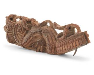 1261 An Asian carved wood architectural element Possibly Indian, 19th/20th century The S-curve corbel carved with scrolling foliage Height 23 1/2 in., width 7 1/4 in., depth 3 in. Estimate: $200 - $300