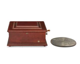 1026 A Symphonion mahogany music box 20th century, with later elements Impressed to inner plate: 11853; numbered to paper label: Symphonion no. 43 / Requires Disc no. 143; with applied plaque: FROM THE SOUTHERN CALIFORNIA MUSIC CO., LOS ANGELES, CAL. With star flywheel and an 80-teeth comb, housed in a wood box and with seven 15 3/4 in. diameter discs 8 pieces Case height 10 1/2 in., width 24 in., depth 20 in. Estimate: $300 - $500