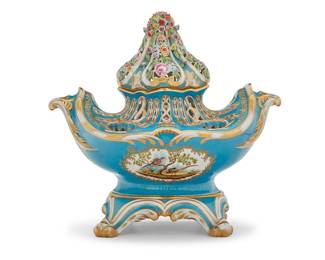1213 A Herend porcelain potpourri gondola Second half 20th century, after the Sevres model Bowl and stand each with blue printed factory mark above painted shape number: 6505 / II With pierced lid with delicate floral elements in relief, above the pierced bowl with gilt highlights, each side painted with a scene of birds in a tree, raised on a stand with scroll feet 3 pieces Overall height 14 in., width 15 1/4 in., depth 8 in. Estimate: $400 - $600
