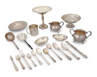 1004 A group of sterling silver table items 20th century Each marked with factory marks for sterling Comprising an open sugar, creamer, cup, bowl, two nut dishes, various utensils, and a weighted sterling compote and weighted footed bowl, from makers such as Wallace, Reed & Barton, Gorham, and others, together with a silvered metal and wood tea strainer 21 pieces Compote height 6 1/4 in., diameter 6 1/8 in. Total weighable sterling 18.8 gross oz. approximately Estimate: $300 - $500