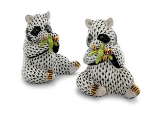 1221 A pair of Herend porcelain black fishnet panda bears Late 20th century Each with blue printed factory mark above painted numbers: 15348 / VHNM / E 97 2 pieces Height of each 5 in., width 4 1/4 in., depth 3 5/8 in. Estimate: $200 - $400