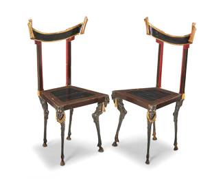 1192 A pair of Surrealist style side chairs 20th century Each parcel-gilt crest rail with scrolled ends, raised on goat-leg-form feet, with beast masks at the front corners 2 pieces Height of each 35 1/4 in., width 17 in., depth 15 3/4 in. Estimate: $300 - $500