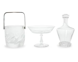 1333 Three glass table items Late 20th/early 21st century Each etched with factory mark Comprising: St. Louis 'Diamant' stopped bottle (height 7 1/2 in., diameter 4 in.) Val St. Lambert 'Concerto' compote (height 4 5/8 in., diameter 6 3/8 in.) Lalique 'Artois' ice bucket with silver-plated handle (height 4 3/4 in.) 3 pieces Estimate: $300 - $500