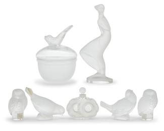 1349 A group of seven Lalique glass table items 20th/early 21st century Deux Fleurs with etched stencil mark: Lalique / France; the others etched: Lalique France [or] Lalique ® France Comprising a 'Deux Fleurs' perfume bottle, 'Igor' lidded caviar bowl, pair of owls, two birds, and a maiden after 'Girl in the Wind' by Desna 7 pieces Tallest height 8 5/8 in., width 3 7/8 in., depth 2 1/4 in.; height of owls 3 1/2 in. Estimate: $400 - $600